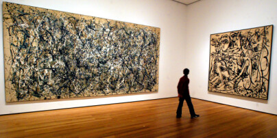 A visitor strolls by the artwork of Jackson Pollock at the Museum of Modern Art, Wednesday, April, 13, 2005 in New York. Four months after unveiling its spectacular new quarters in midtown and taking heat for sharply higher entry fees, the Museum of Modern Art has already registered more than 1 million visitors. (AP Photo/Mary Altaffer)